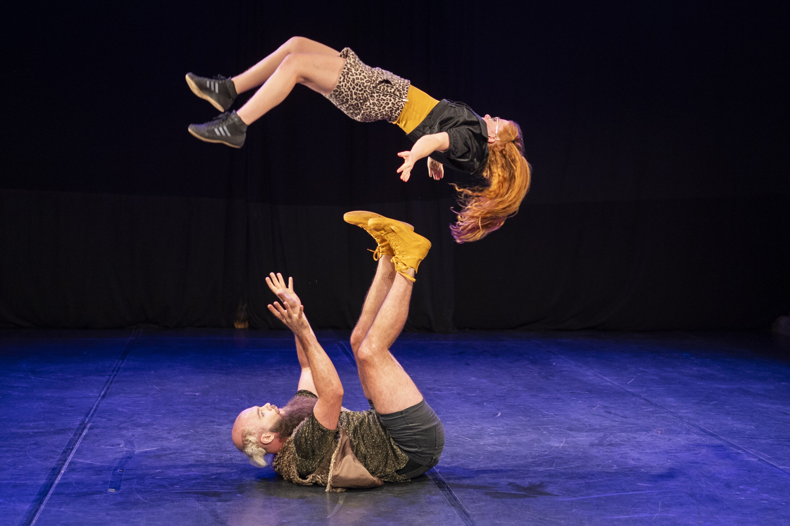 A female performer is spun through the air by a male performer lying on the ground. This is the duo Ginger Moustache, who performed at the Zirkusquartier in Zurich in 2024. 